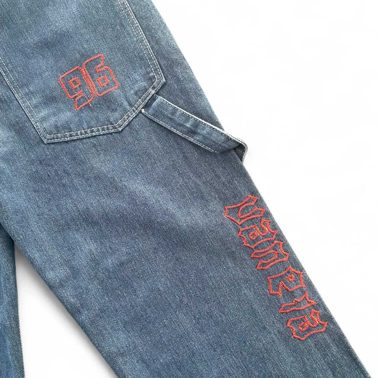 Denim blue jeans with red embroidery
