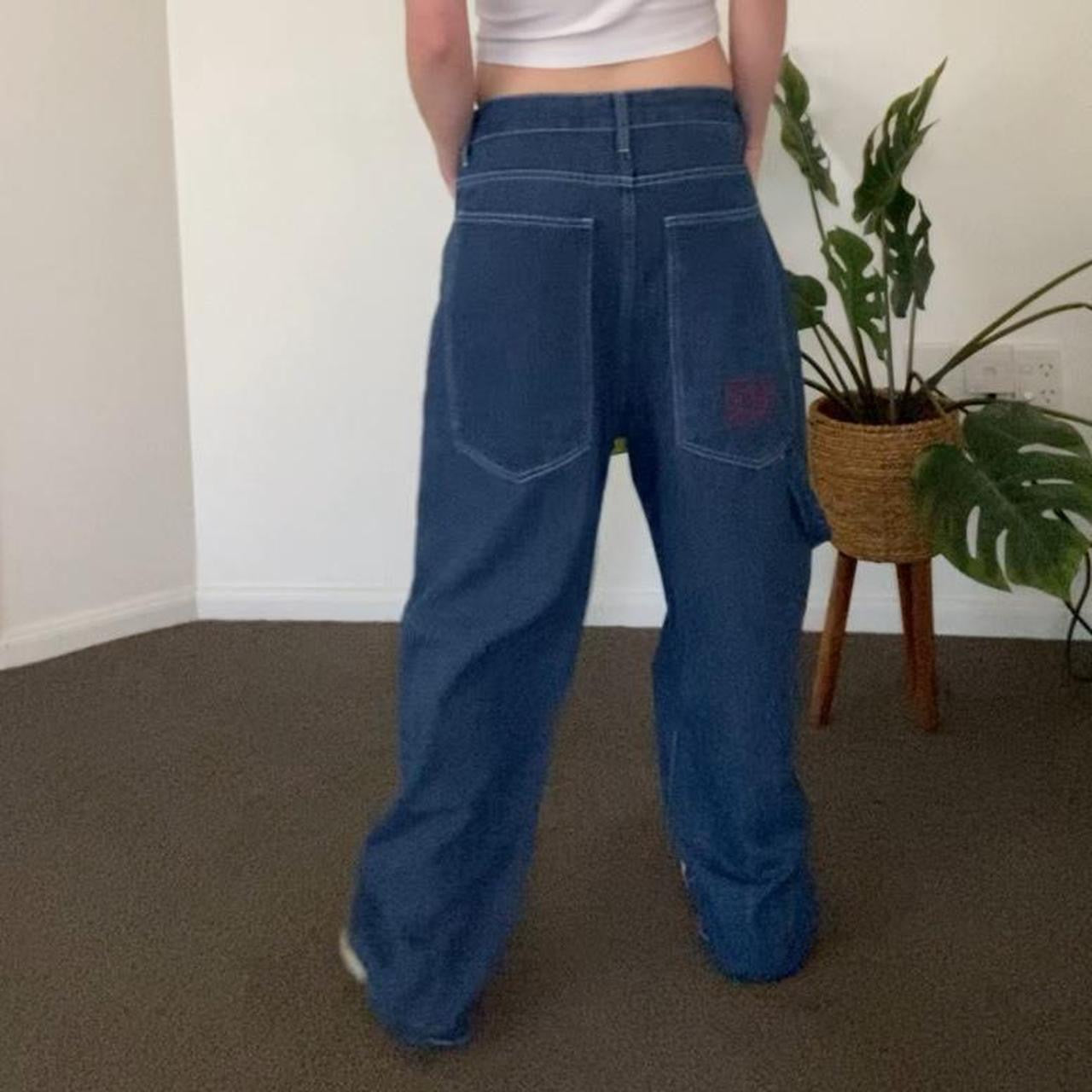 Denim blue jeans with red embroidery