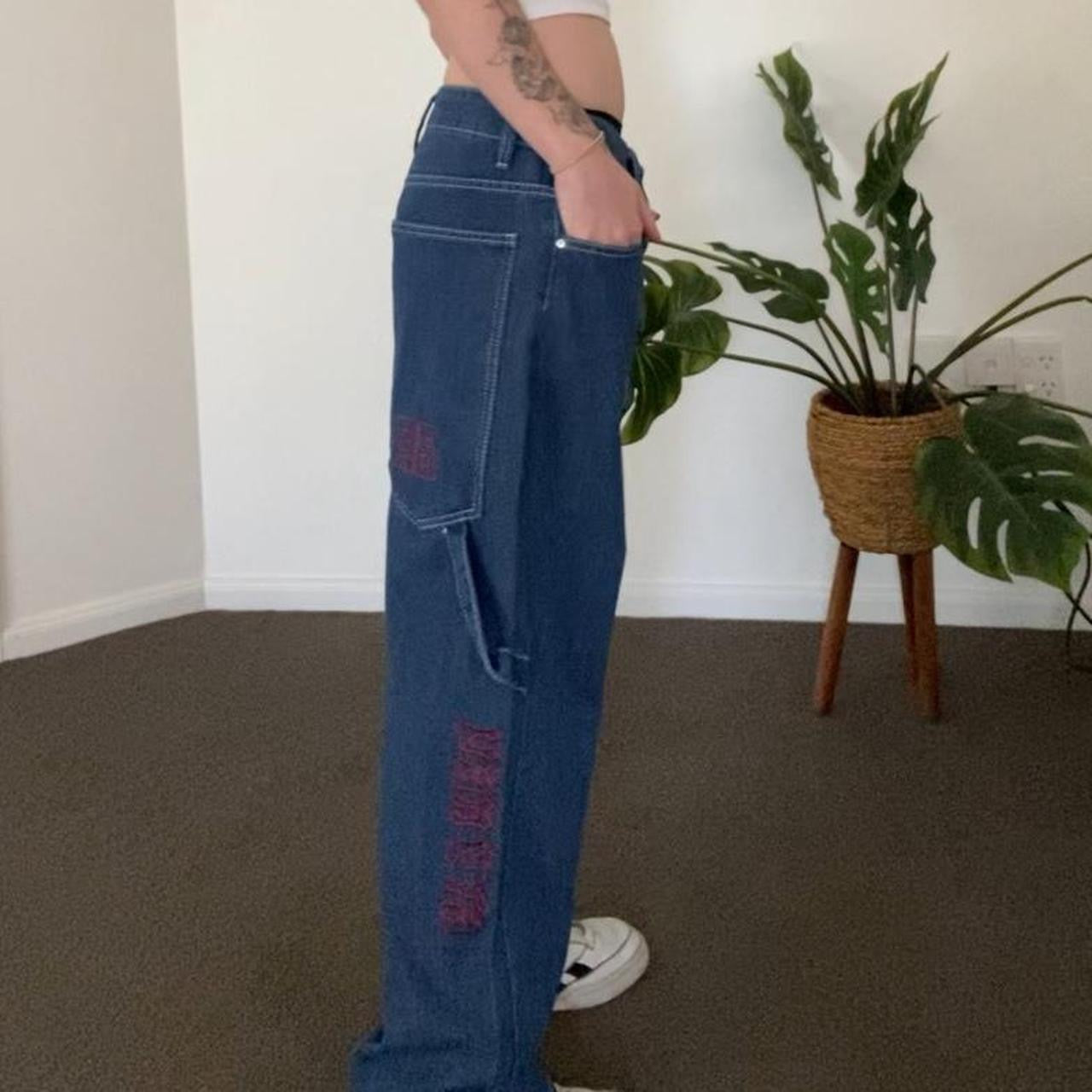 Denim blue jeans with red embroidery