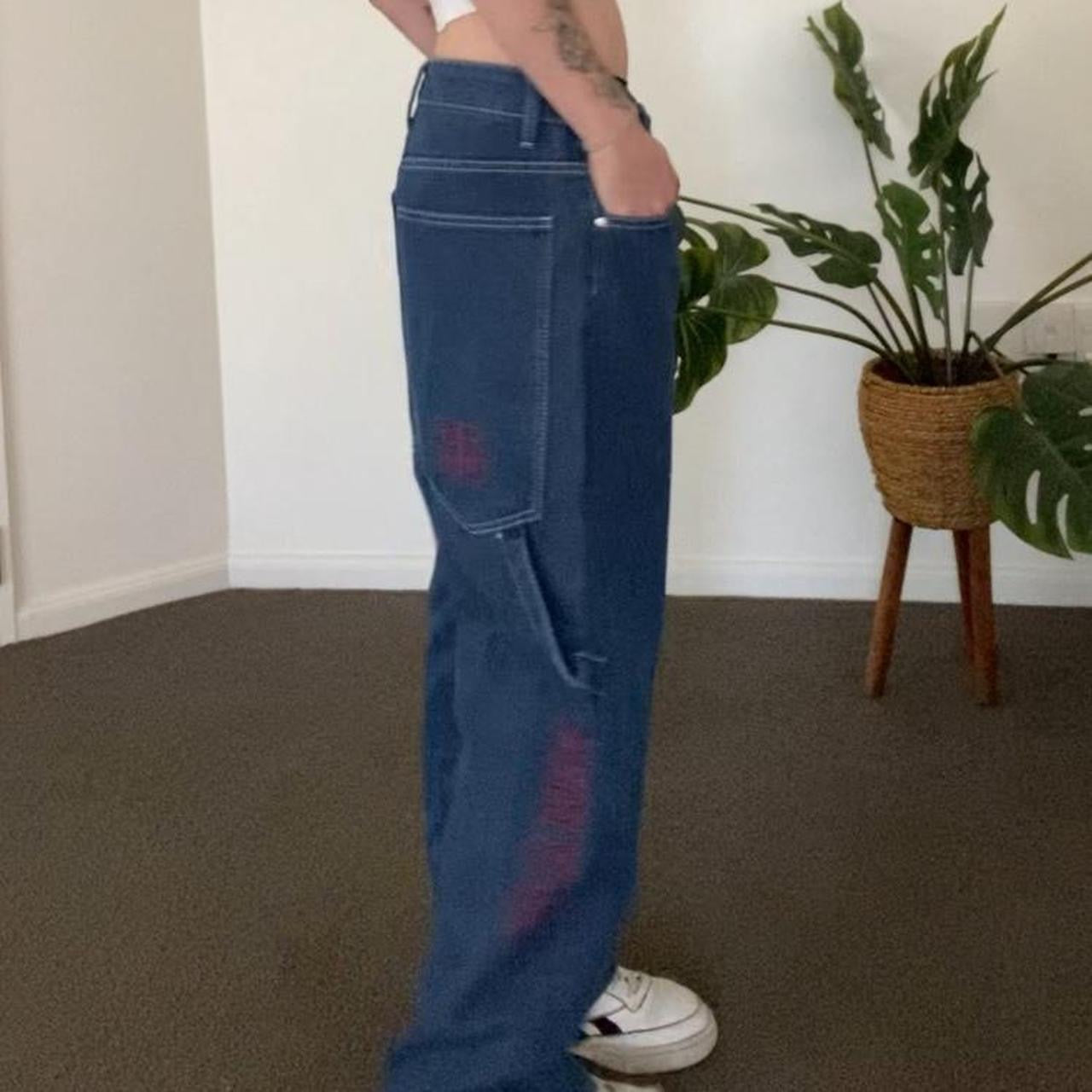Denim blue jeans with red embroidery