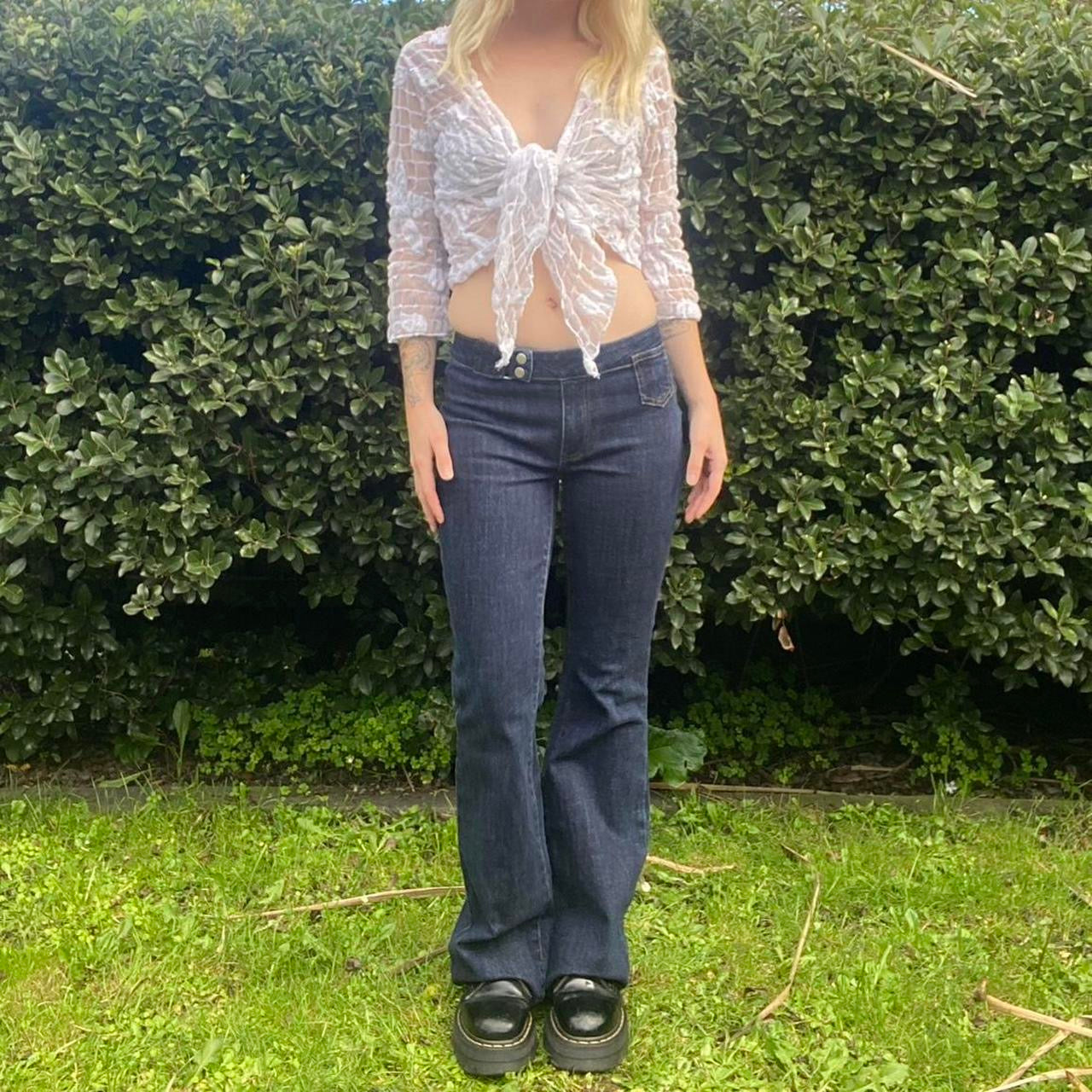 Low-rise flare jeans with button belt detail