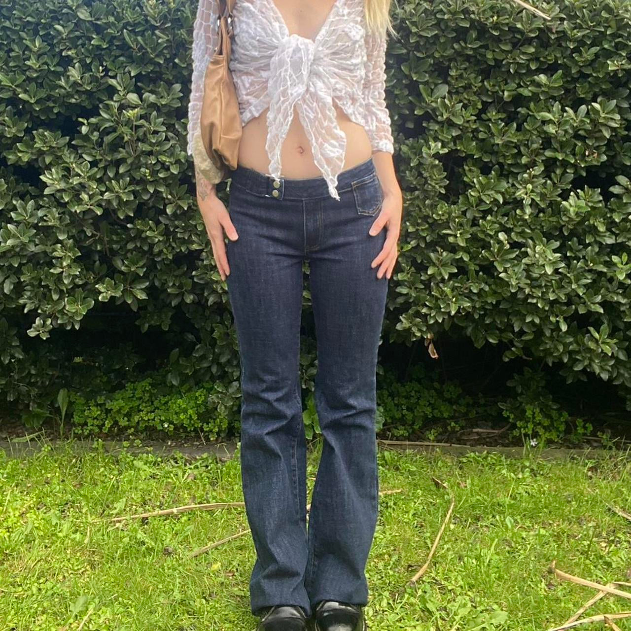 Low-rise flare jeans with button belt detail