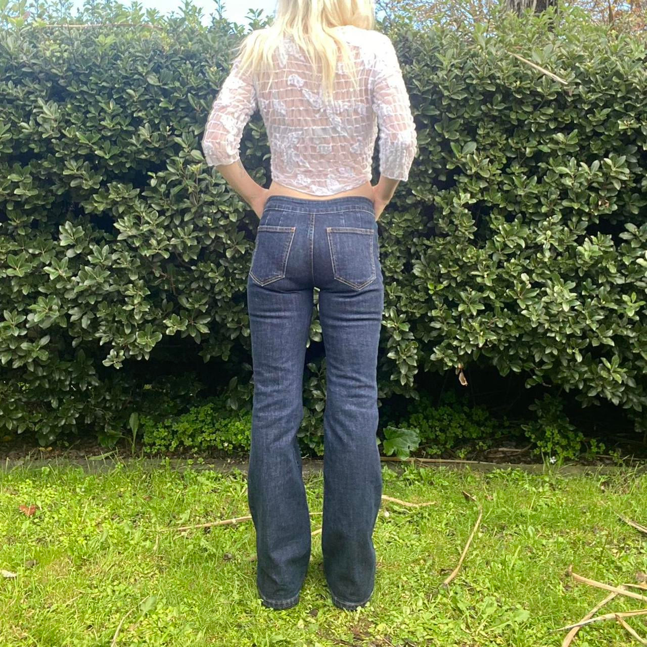 Low-rise flare jeans with button belt detail